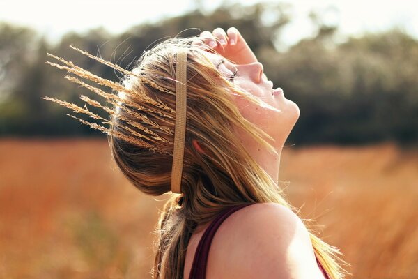 A girl in a pro with ears of corn