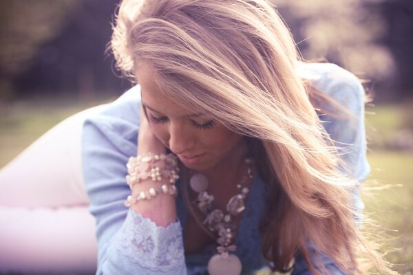 Pensive blonde in with massive jewelry