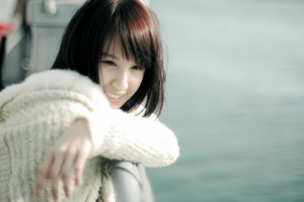 Portrait of a girl in a sweater at sea