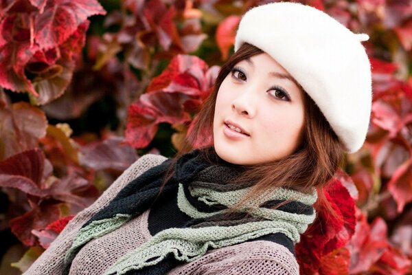 Beautiful girl in a beret in nature