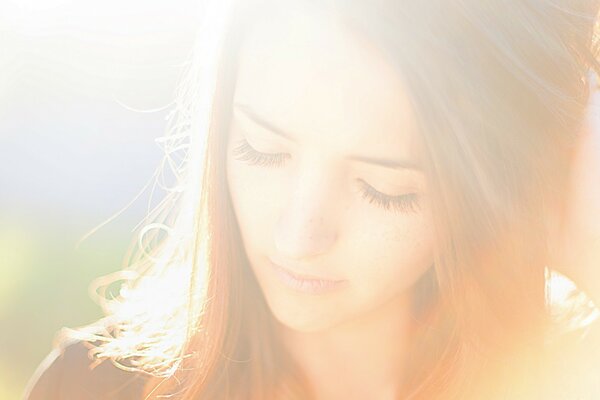 A dreamy image of a girl in the rays of the sun