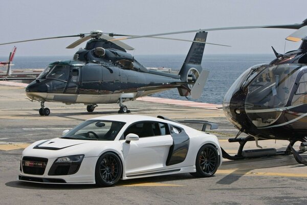 Sports car on the background of helicopters