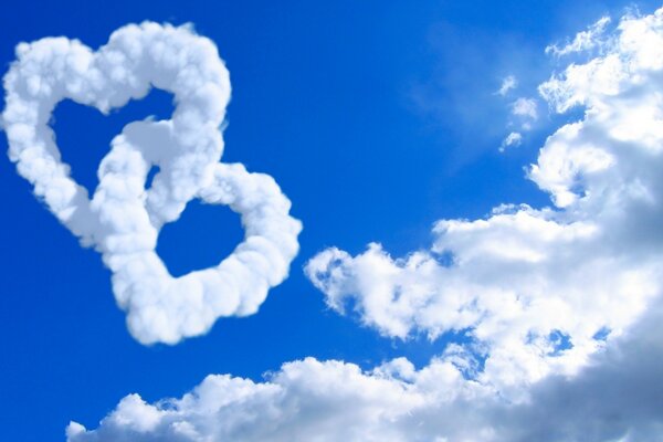 The clouds in the blue sky formed two hearts