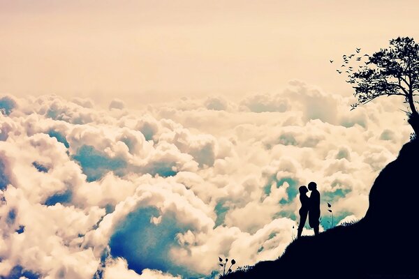 Pareja enamorada en una montaña por encima de las nubes