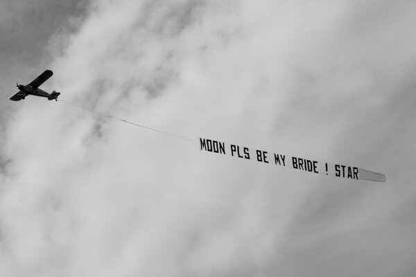 Airplane. Cloudy weather. Inscription