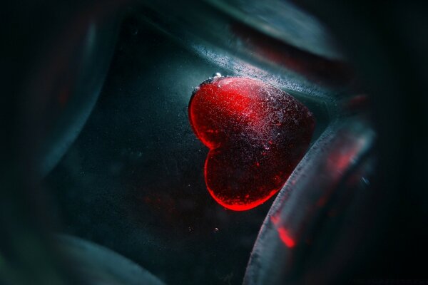 Red, icy heart on a dark background