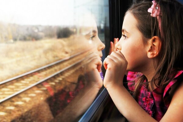 A girl looks out of the train window