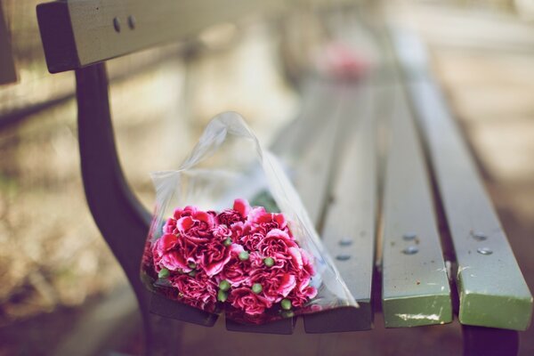 Bouquet of flowers on a bench in the park