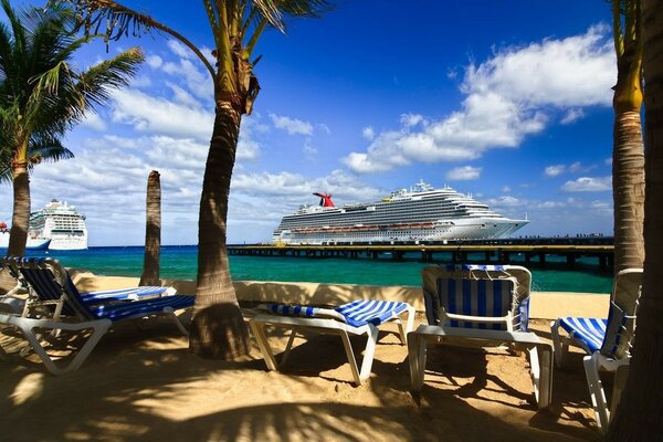 Striped sunbeds on the background of cruisers