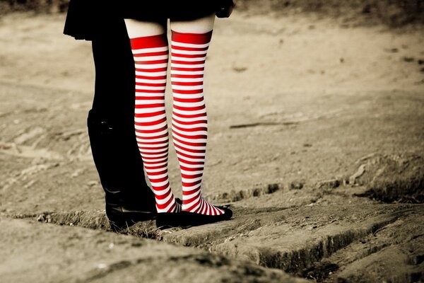 A girl in red leggings is standing on the road