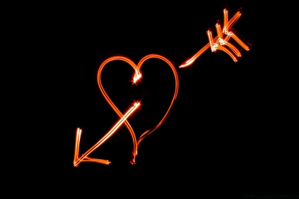 A heart pierced by an arrow on a black background