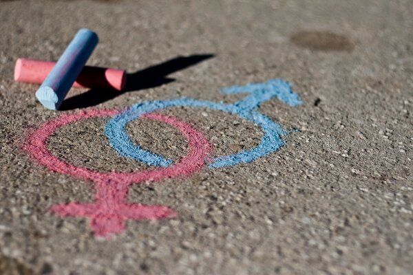 Venus and Mars crayons on asphalt