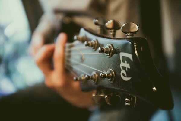 Guitar neck with a person playing