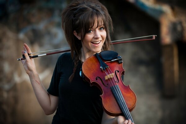 A violinist girl with a musical instrument in her hands