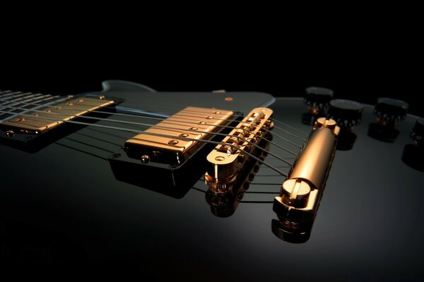 Acoustic electric guitar in black with gold strings