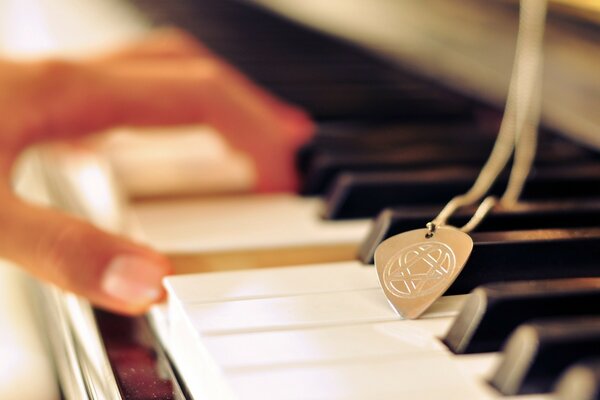 Beautiful female hand on the piano