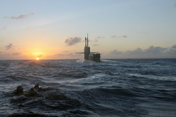 Sunset. The submarine lifts out of the water