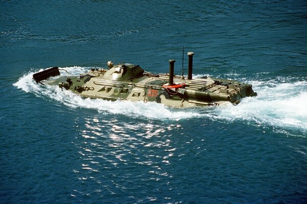 A military vehicle is crossing the water