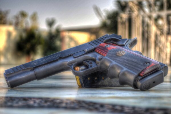 The gun of the criminal on a granite covering