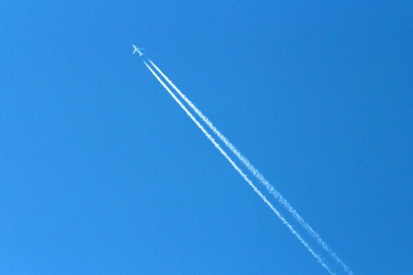 The trace of the plane in the blue sky