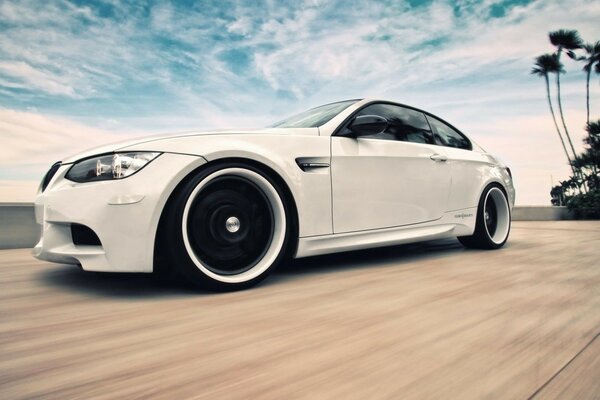 White sports car with black wheels