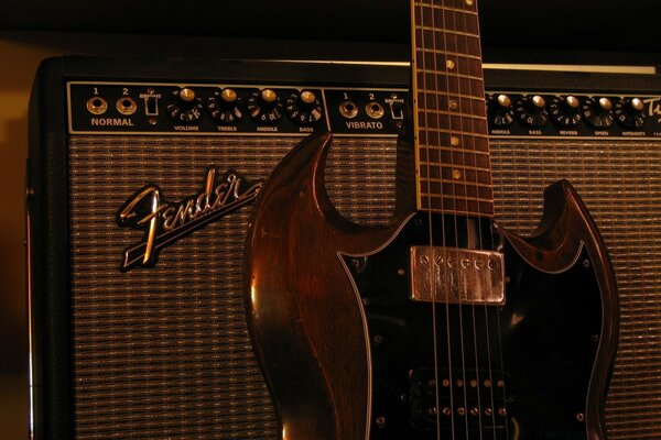 Guitar on the background of an amplifier, a musical instrument