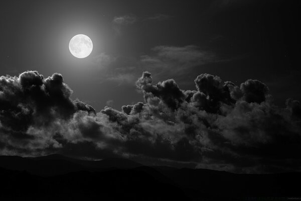 Imagen del cielo con la Luna y grandes nubes negras