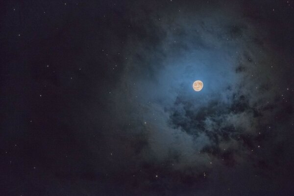 A small moon at night among the clouds