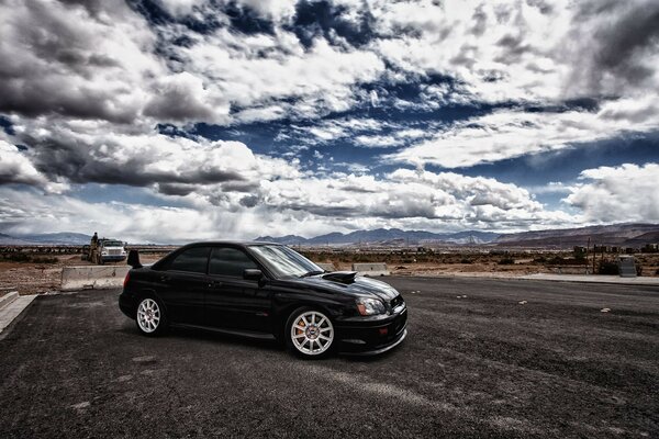 Black sports car on asphalt