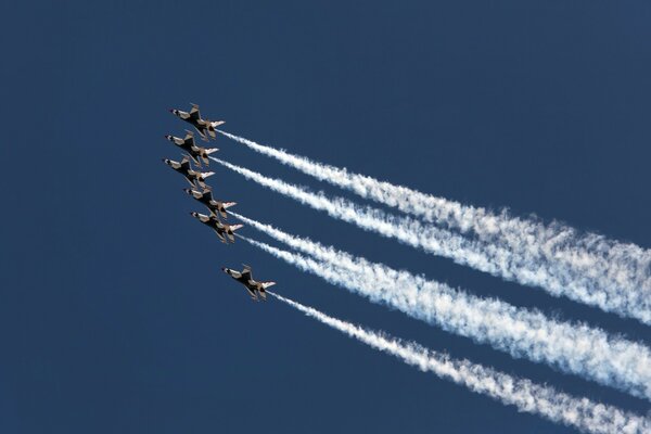 Several planes perform aerobatics