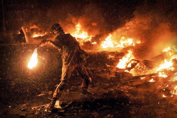 Aggressiver Infanterist wirft im Feuer einen Molotowcocktail