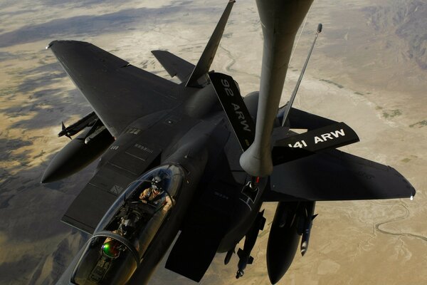 A picture of a fighter refueling in the air