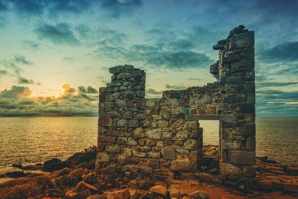 A ruined wall on the background of the sea