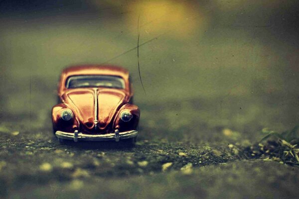 A toy retromobile is lying on the road