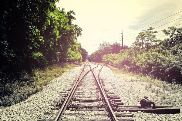 Railway arrow and rails on the railway embankment