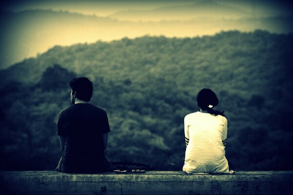 A man and a woman are sitting together