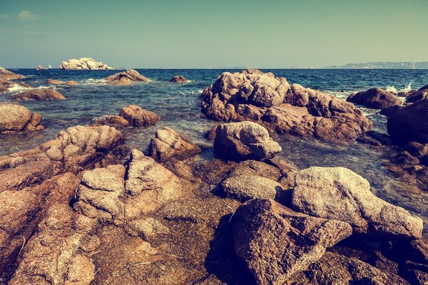 Stones by the sea. Beautiful sky in the palm of your hand