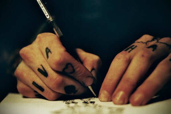Tattooed writer s hands note