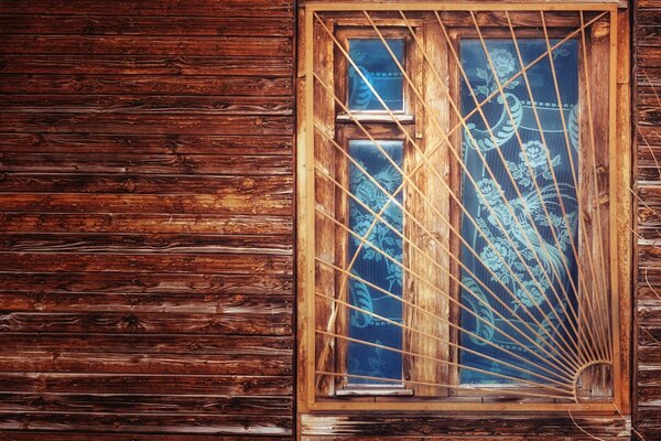 Wooden window frame behind bars