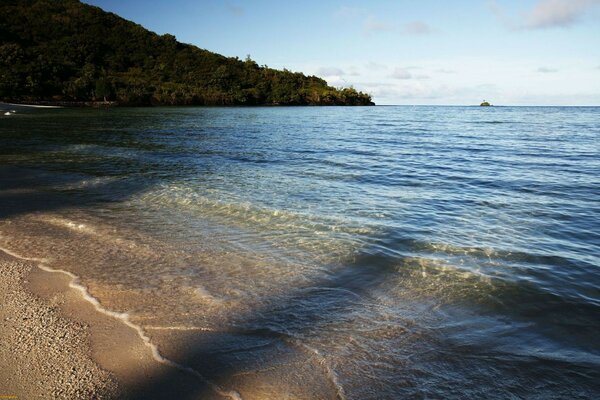 Sea beach on the background of a gentle mountain