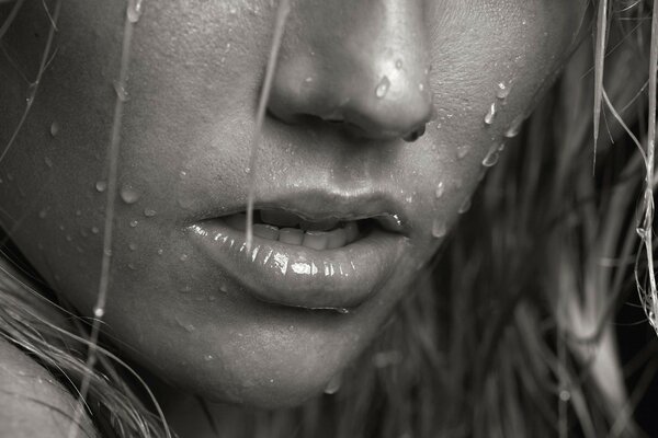 Monochrome photo of a girl with drops on her face