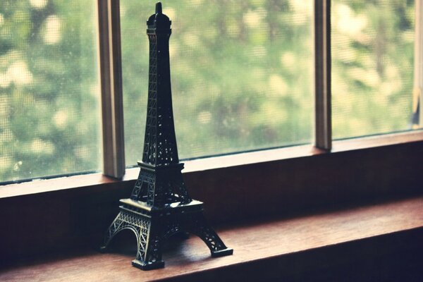 Eiffel Tower statuette by the window