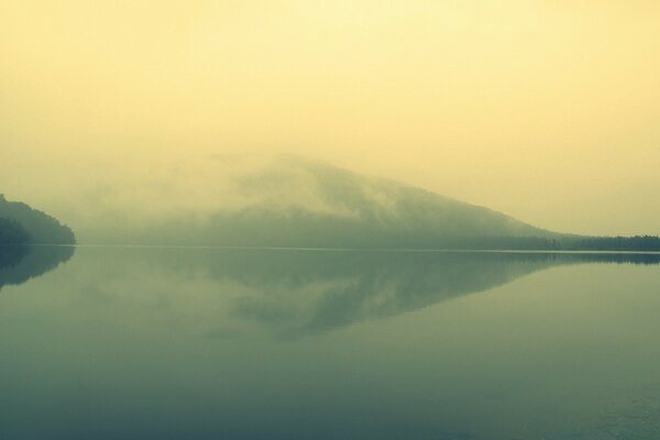 Fog enveloping the mountain and lake