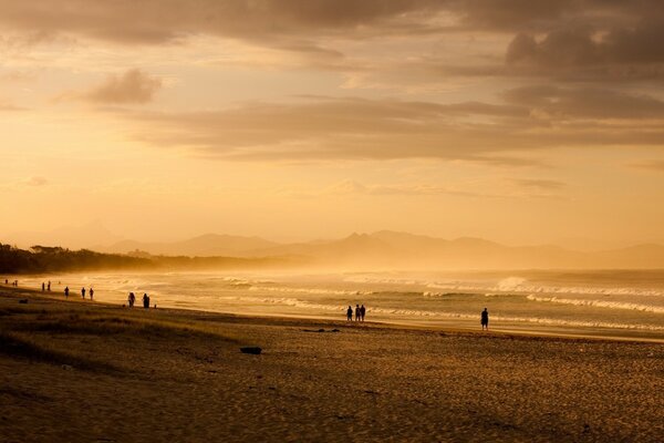 A walk on the sea beach at sunset