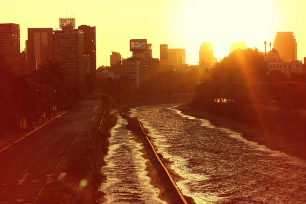 Sunset over the city and waves