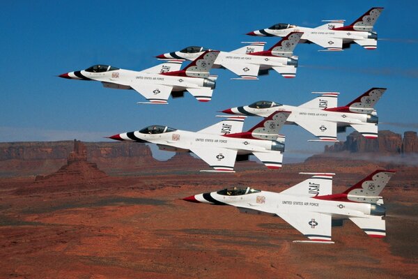 Harbingers of the storm flying in formation over Monument Valley