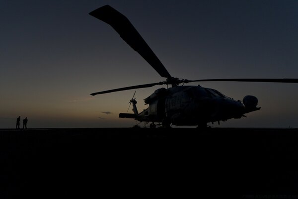 Sleeping helicopter, car on the ground, night landscape