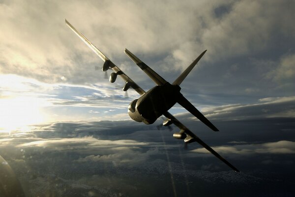 The plane flies through the sky during the day