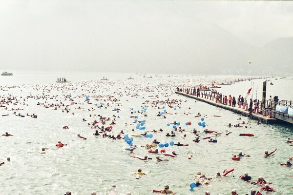 Foggy seashore full of people