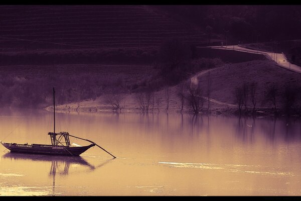 A lonely canoe on the sea surface